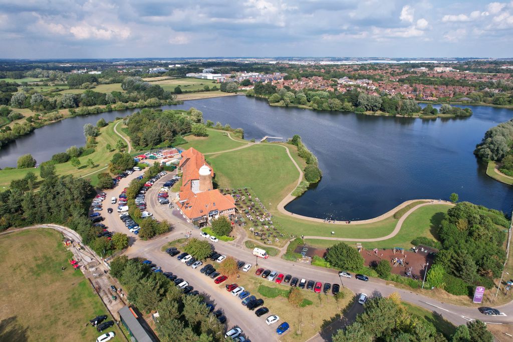 Aerial view capturing the scenic landscape of Caldecotte Lake, England during summer.